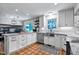 Bright kitchen with stainless steel appliances, granite countertops, and white cabinetry at 8156 Nc 42 Hwy W, Kenly, NC 27542
