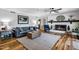 Comfortable living room with a brick fireplace, wood floors, and stylish furniture creating a welcoming atmosphere at 8156 Nc 42 Hwy W, Kenly, NC 27542
