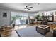 Spacious living area features wood floors, sliding glass doors, and ample seating perfect for entertaining guests at 8156 Nc 42 Hwy W, Kenly, NC 27542