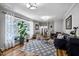 Bright living room with large windows, hardwood floors, and a stylish rug at 8156 Nc 42 Hwy W, Kenly, NC 27542