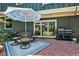 Inviting outdoor patio is ideal for dining and grilling, complete with furniture, umbrella, and grill at 8156 Nc 42 Hwy W, Kenly, NC 27542
