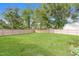 Large, fenced backyard with a well-maintained lawn and mature trees at 96 Landmark Dr, Angier, NC 27501