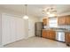 Functional kitchen with stainless steel appliances, wood cabinets, and a view of the backyard at 96 Landmark Dr, Angier, NC 27501