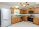 Well-lit kitchen with granite countertops, stainless steel appliances, and wood cabinetry at 96 Landmark Dr, Angier, NC 27501