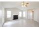 Spacious living room featuring vaulted ceilings, a fireplace, and ample natural light from large windows at 96 Landmark Dr, Angier, NC 27501