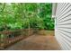 An outdoor deck and backyard surrounded by lush greenery, creating a serene and private outdoor space at 100 Culbreth Rd # C, Chapel Hill, NC 27516