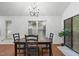 A dining area featuring a modern chandelier and a view of the backyard through sliding glass doors at 100 Culbreth Rd # C, Chapel Hill, NC 27516