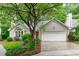 Charming home with a two-car garage, lush green lawn, mature trees, and well maintained landscaping at 100 Culbreth Rd # C, Chapel Hill, NC 27516