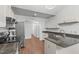 Modern kitchen featuring stainless steel appliances, granite countertops, and sleek white cabinets at 100 Culbreth Rd # C, Chapel Hill, NC 27516