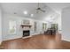 An open-concept living room featuring a fireplace, ceiling fan, light fixtures, and connection to the dining area at 100 Culbreth Rd # C, Chapel Hill, NC 27516