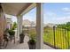 Scenic balcony view with patio seating, greenery, and distant homes in a residential community at 10310 Sablewood Dr # 111, Raleigh, NC 27617