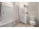 Bathroom featuring tub, shower with curtain, vanity, toilet and neutral color palette at 10310 Sablewood Dr # 111, Raleigh, NC 27617