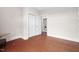 Bedroom with hardwood floors and ample storage space leading to in-unit laundry closet at 10310 Sablewood Dr # 111, Raleigh, NC 27617