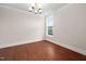 Dining room with hardwood floors, modern chandelier, and view of the backyard at 10310 Sablewood Dr # 111, Raleigh, NC 27617