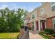 Exterior view of townhomes featuring a side walkway, landscaping, and upper-level balconies at 10310 Sablewood Dr # 111, Raleigh, NC 27617