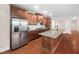 Open kitchen featuring stainless steel appliances, granite countertops, and custom cabinetry at 10310 Sablewood Dr # 111, Raleigh, NC 27617