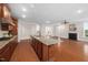 A kitchen island features granite countertops and sink with an open view of the living room at 10310 Sablewood Dr # 111, Raleigh, NC 27617