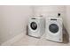 Laundry room complete with full-size, white, front-loading washer and dryer at 10310 Sablewood Dr # 111, Raleigh, NC 27617