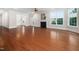 A modern living room with a fireplace, hardwood floors, and lots of natural light from the windows at 10310 Sablewood Dr # 111, Raleigh, NC 27617