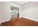 Open dining room with hardwood floors, modern chandelier, and an open view to the kitchen at 10310 Sablewood Dr # 111, Raleigh, NC 27617