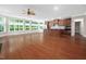Spacious open-plan living area with hardwood floors, a ceiling fan, and a modern kitchen at 10310 Sablewood Dr # 111, Raleigh, NC 27617