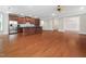Open-concept living space with hardwood floors, a ceiling fan, and a modern kitchen at 10310 Sablewood Dr # 111, Raleigh, NC 27617