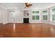 Bright living room featuring a fireplace, ceiling fan, hardwood floors, and lots of natural light at 10310 Sablewood Dr # 111, Raleigh, NC 27617