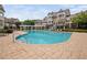 Community pool with resort-style lounge chairs, pergola and manicured landscaping at 10310 Sablewood Dr # 111, Raleigh, NC 27617