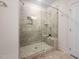 Walk-in shower with glass surround, tile walls, and convenient built-in shelving at 10310 Sablewood Dr # 111, Raleigh, NC 27617