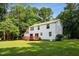 Spacious backyard with a large lawn and deck, surrounded by mature trees for added privacy at 104 Benedict Ln, Raleigh, NC 27614