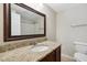 Bathroom vanity features granite countertops, framed mirror, and sink at 104 Benedict Ln, Raleigh, NC 27614