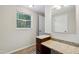 Bathroom featuring updated vanity and granite counter, mirror and window providing ample light at 104 Benedict Ln, Raleigh, NC 27614