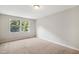 Bedroom featuring neutral carpet, a window providing natural light, and a calming atmosphere at 104 Benedict Ln, Raleigh, NC 27614