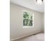 Bedroom showcasing a window overlooking a wooded area, providing serene natural light at 104 Benedict Ln, Raleigh, NC 27614