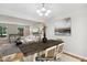 Staged dining area featuring a rustic wood table, contemporary lighting, and an open-concept design at 104 Benedict Ln, Raleigh, NC 27614