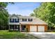 Charming two-story home featuring blue shutters, brick accents, a two-car garage, and a lush front lawn at 104 Benedict Ln, Raleigh, NC 27614