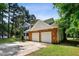 Charming two-car garage home featuring a brick-accented facade and a well-maintained driveway at 104 Benedict Ln, Raleigh, NC 27614