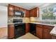 Well-appointed kitchen with granite countertops, wood cabinets, and stainless steel appliances, offering style and functionality at 104 Benedict Ln, Raleigh, NC 27614