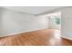 Bright living room featuring hardwood floors, a neutral color palette, and natural light from a large window at 104 Benedict Ln, Raleigh, NC 27614