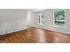 Inviting living room featuring wood floors, bright windows, and a neutral paint palette, ready for your personal touch at 104 Benedict Ln, Raleigh, NC 27614
