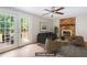 Inviting staged living room with a brick fireplace, French doors, and comfortable seating at 104 Benedict Ln, Raleigh, NC 27614