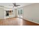 Open living room with hardwood floors and french doors leading to backyard deck, and passthrough to kitchen at 104 Benedict Ln, Raleigh, NC 27614