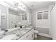 Bright bathroom featuring a double vanity with granite countertops and white cabinets at 105 Litchfield Ct, Rocky Mount, NC 27803