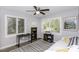 Bright bedroom with two windows, hardwood floors, ceiling fan, and a comfortable bed at 105 Litchfield Ct, Rocky Mount, NC 27803