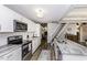 Modern kitchen boasts stainless steel appliances, gray countertops and connects seamlessly to the staircase at 105 Litchfield Ct, Rocky Mount, NC 27803