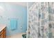 Well-lit bathroom with a coastal themed shower curtain and blue wall at 107 Canyon Run, Cary, NC 27513