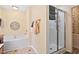 Bright bathroom featuring a soaking tub, a glass shower, and neutral walls at 107 Canyon Run, Cary, NC 27513