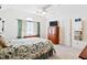 Bright bedroom with a floral-patterned bed, ceiling fan, and natural light from a large window at 107 Canyon Run, Cary, NC 27513