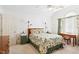 Bright bedroom with a floral-patterned bed, ceiling fan, and desk and window at 107 Canyon Run, Cary, NC 27513
