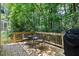 Outdoor deck with natural wood, seating, and a view of the lush surroundings at 107 Canyon Run, Cary, NC 27513